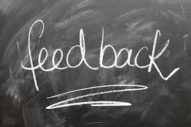 A blackboard showing the word 'feedback' written in white chalk