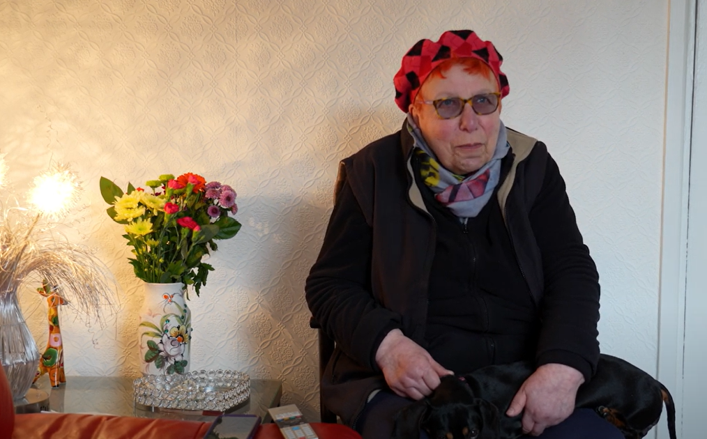 old lady with dog on lap