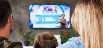 Family watching TV with sign language interpreter