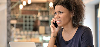 Angry woman using telephone