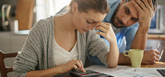 Couple at table with calculator